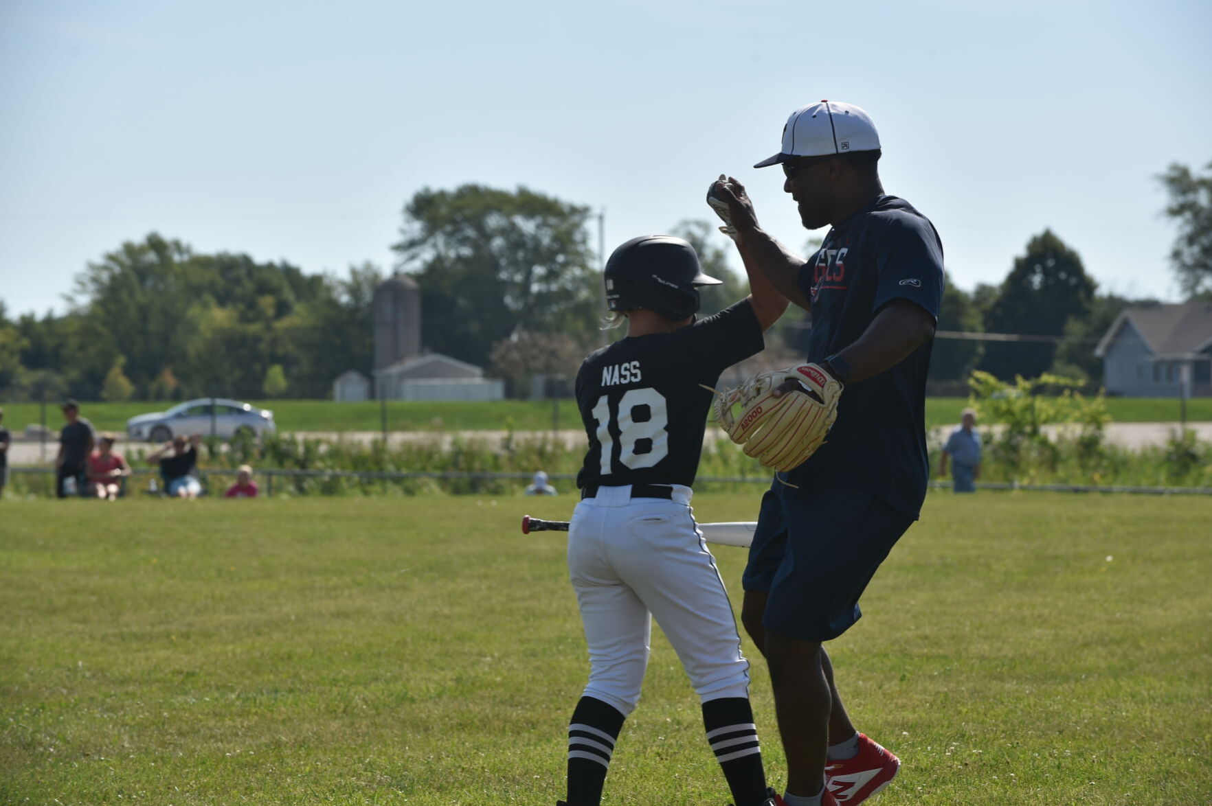 Coach Rafael Carrasquillo congratulates Tavin Nass on another successful round